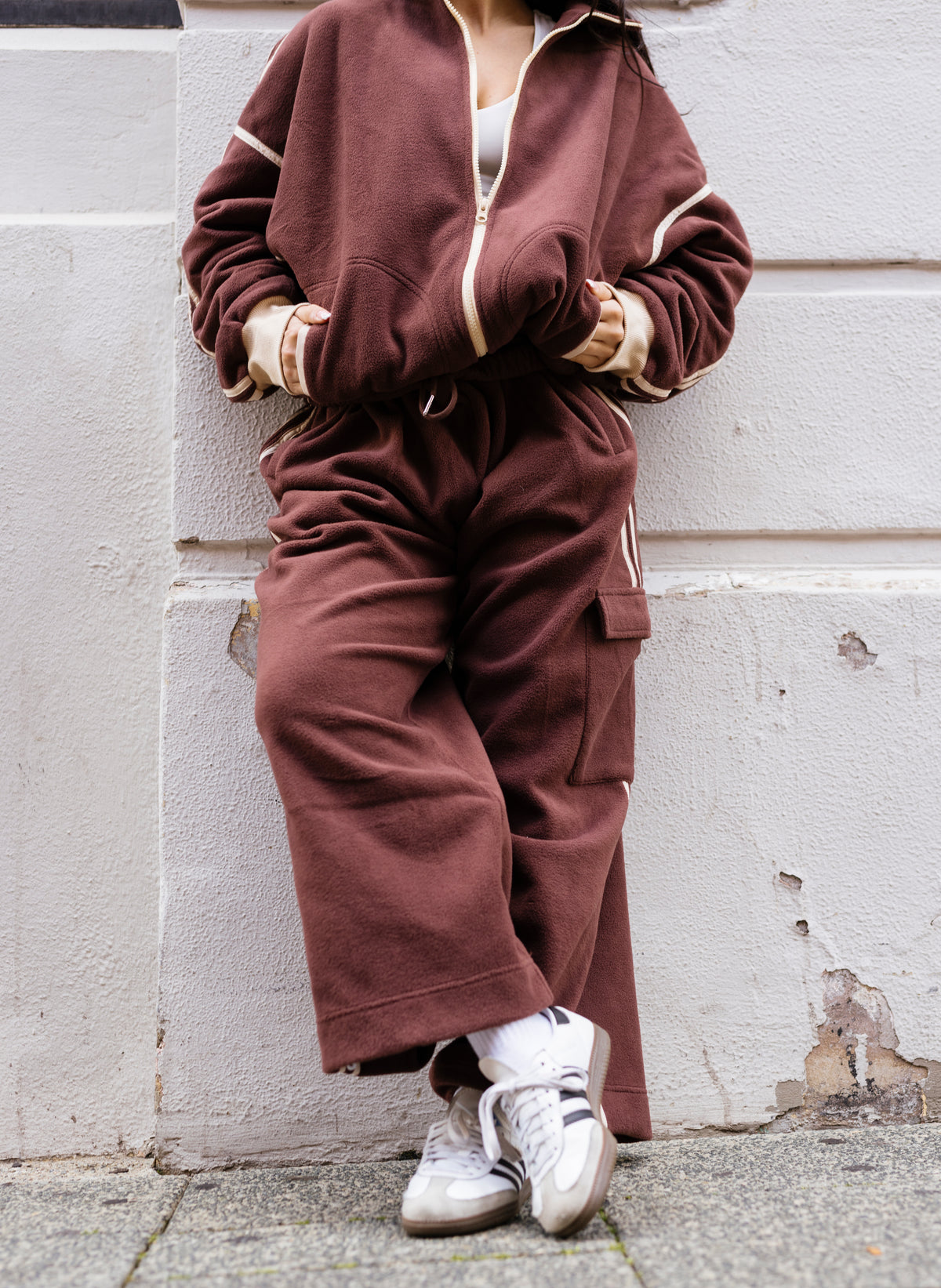 Brown fleece track pants with signature stripe detail