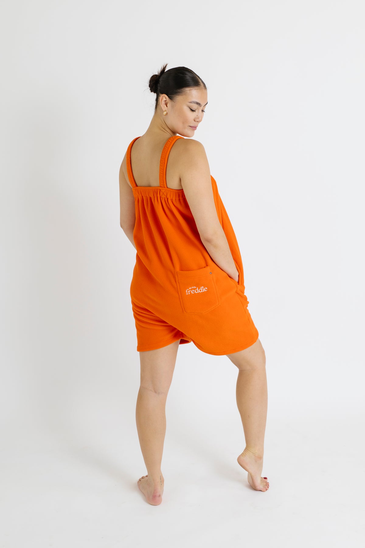 Orange short onesie in 100% polyester polar fleece