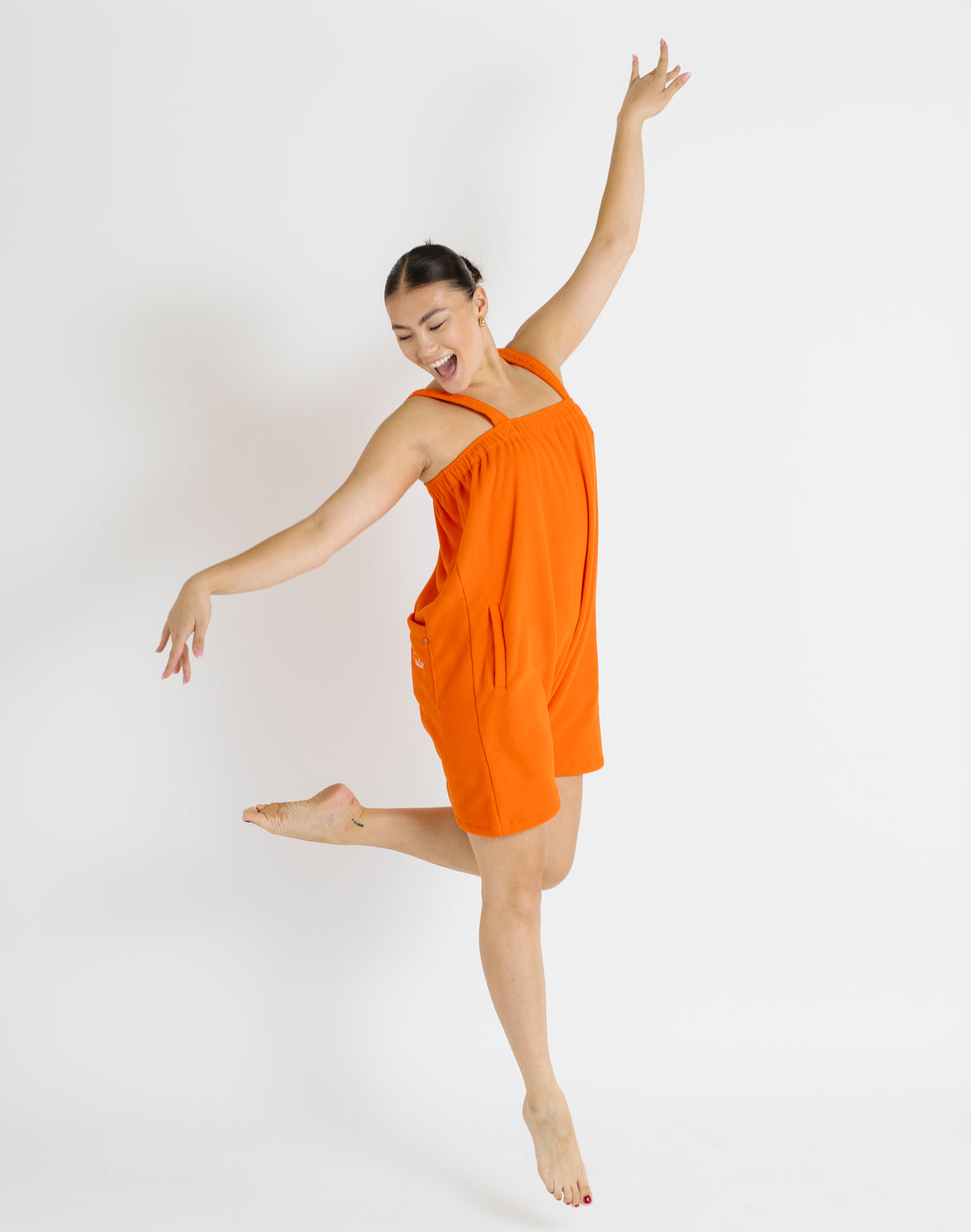 Orange short fleece onesie for getting ready